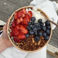 Açai bowl with fruit, granola, coconut flakes and peanut butter💗 at GAIA's GARDEN in Barcelona