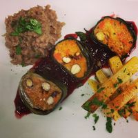 Mangold rolls filled with a vegetable farce and hazelnuts, mixed sauteed vegetables on plum sauce  at Bodhi in Munich
