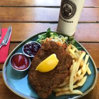 Schnitzel Vienna Style (with French fries and side salad under the schnitzel)  at Bodhi in Munich