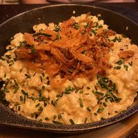 Käsespätzle: tiny noodles smothered in creamy cheesy sauce, served with caramelized onions and chives, as well as a side salad. Very authentic   at Bodhi in Munich