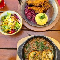typical bavarian food. Crispy soy steak with potato dumpling and a mushroom ragout with bread dumplings at Bodhi in Munich