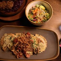 mushroom ravioli, fried onions, walnuts and cherry tomatoes with side salad  at Bodhi in Munich