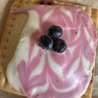 Blue berry poptart with frosting and topped with fresh blueberries   at Hold the Wheat in St Louis Park