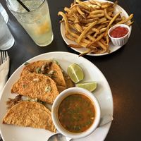 Quesabirria mushroom tacos with a side of fries and a mocktail.  at Handlebar in Chicago