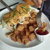 Fried green tomato Benedict with home fries at Handlebar in Chicago