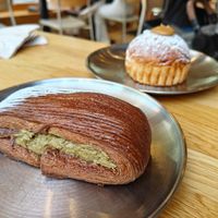 Dubai chocolate croissant and brioix filled with cream and lotus from a more cinematic angle at Magma Bakery Lab  in Barcelona