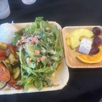 Vegetable tofu stir fry, sticky white rice, salad, and fruit pictured. Options depend on availability, must email ahead so they can prepare the dish for you.  at Toa Luau in Haleiwa