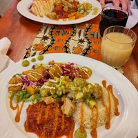 Two different vegan dishes in the photo: Maira and vegan version of Attieke. Both have "no-chicken" in them. Senegalese style ginger-pinapple juice and hibiscus juice at the side. at Maira African Soul Food in Tampere