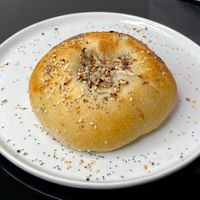 white onion + poppy bialy (plated at home) at Hey Bagel  in Seattle