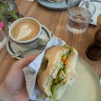 Vegan bagel with hummus, avocado and vegetables & cappuccino with oat milk at PIJAT in Vienna
