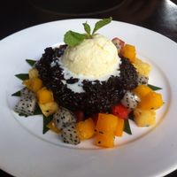 Sticky black rice with ginger ice cream and fresh fruit ($4,50) at Sandan in Sihanoukville