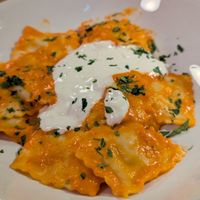 Ravioli Nduja e Stracciatella:  Fresh ravioli stuffed with Nduja and creamy cheese served with a smooth sweet red pepper sauce topped with a fresh dollop of stracciatella chees at Sora Diana in Edinburgh