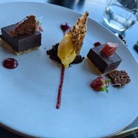 Vegan chocolate tart, bitter chocolate crumbs, peach & wild berry compote, mixed berry
fluid gel, salted almond tuille, mandarin sorbet at Panorama Room in Mt Cook