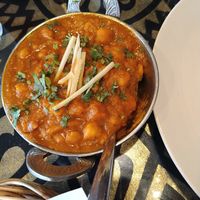 Chana Amritsari is vegan. Mild is delicious when supporting all spices in dish, medium hot was only hot( not given any higher value)- my opinion 😁. Ginger sticks on top the dish at Tandoori Night's Restaurant in Ao Nang