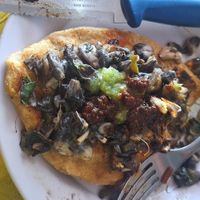 Faba bean tlacoyo topped.with corn fungi mushrooms at La Chilanga ES in Mazatlan
