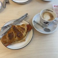 Bacon and cheese croissant and cafe latte   at Black Cat Santiago in Santiago De Compostela
