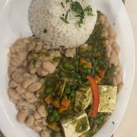 SECO DE TOFU - Cilantro based tofu stew with peas and carrots. Served with beans and white rice.  at Gabby's Peruvian Restaurant in Wichita