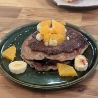 Pancakes with chocolate sauce, banana and orange at fronda cafe  in Valencia