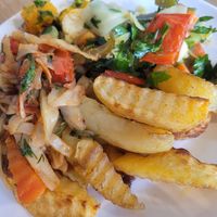 Massive plate of roast vegetables with chimichurri, braised cabbage in tomato sauce, and roast potato wedges. Everything was SO tasty! at Art Lunch in Yerevan