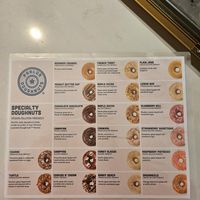 Variety of flavors 2ith the vegan ones clearly marked at Parlor Doughnuts in Bolingbrook