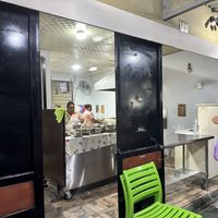 From sidewalk/ outdoor seating area  at Pupusería La Ceiba in Santa Ana