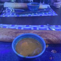 Dosa (pancake) and it's pot of sauce at Bites of India Botanic in Belfast