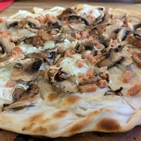 The vegan flammkuchen with La Vie bacon, onion, soy cream and mushrooms. at L'Alsacien Lyon - Bar à Flammekueche in Lyon