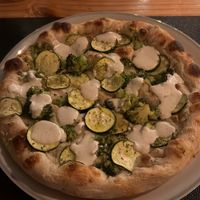 Vegan pizza with cashew cream sauce and broccoli and zucchini   at PRIANI Cuisine in Thoddoo