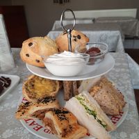 Savoury goodies (tofu-egg mayo and coronation chickpea sandwiches, plus sausage rolls and quiche) and chocolate chip scones with chocolate spread and cream! at All Good Things Vegan in Paignton