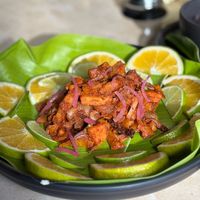 Mushroom Barbacoa, Cooked inside plantain leaf, served with sour orange, guacamole, beans, tortillas and salsas. at Pook in Playa Del Carmen