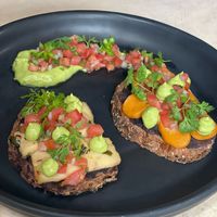 Molletes with homemade Plant based Cheese (Cheddar & Pepper Jack) served with refried beans, pico de gallo and Guacamole. at Pook in Playa Del Carmen