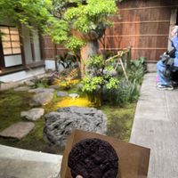 Enjoying the cookie in the Japanese garden beside the cafe behind perfume shop  at LE LABO KYOTO 京町家 in Kyoto