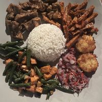 Nasi Campur: tofu with peanut butter, sweet and sour tempe, tempe with long beans, potato fritters  at Warung Gayatri in Abang