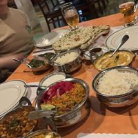 Chana masala, vegetable biryani (Raita on the side for non-vegan friends), tofu paneer. The yellow curry on the right contains chicken (not ours) is not vegan.   at Bombay Palace in Murray