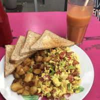 Scrambled tofu with vegan bacon, onions, tomatoes, toast and roasted potatoes  at Mamalicious in Hamburg