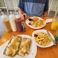 Breaded seitan pizza with caramelized onions and fries and vegan burger with bbq sauce and fries.  I had a mint, ginger lemonade and he had a mango drink.  Yum to all! at RELICIOSO in Buenos Aires