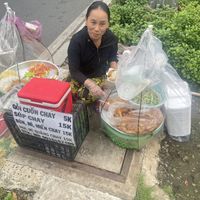 Friendly owner   at Roadside street food stall in Ho Chi Minh City