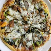 Hawaiian vegan cheese pizza with added tempeh, spinach and mushroom   at H&H Vegetarian Food & Pizza in Vang Vieng