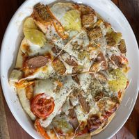 Hawaiian vegan cheese  pizza with added tempeh  at H&H Vegetarian Food & Pizza in Vang Vieng
