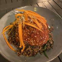 Vegan lentil balls - Lentil & walnut balls in herby tomato sauce with sauteed quinoa & spinach topped with carrot julienne & sesame seeds at Lu-Ma Cafe in South West London