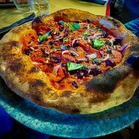 Pizza peperonata: tomato sauce, roasted red peppers, red onions, olives (taggiasche), capers, pine nuts  at Nuvole di Farina in Rome