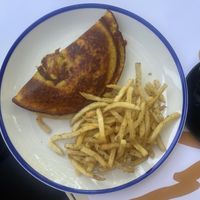 Vegan omelet with tomato and sausage filling with oregano chips  at GNOU in Athens