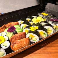 Different types of Sushi arranged with flowers, sideview at BBQ SUSHI MOMO in Gossau