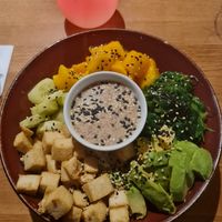 Tofu poke bowl: fried tofu, cucumber, mango, wakame, avocado on a bed of rice with a soy & sesame 'dressing' / 'sauce' at Asian House in Tromsoe