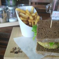 Veggie burger with vegan brown bread and fries. at May and Mark Restaurant in Krabi