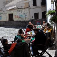 Outdoor seating with Alhambra views at Cafe 4 Gatos in Granada