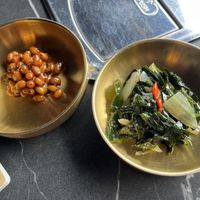 Side dishes. Soy beans on the left might have honey so please check if that concerns you    at Cahchi Korean BBQ Restaurant in New Malden