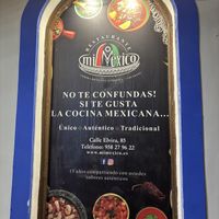 Sign outside confirming address and phone number   at Mi Méjico in Granada