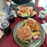 Al pastor burrito w/ side salad; vegan burger made from lentils, beans, peas, oats, carrot; w/ lettuce, tomato, onion, and jalapeños inside; comes w/ potato wedges. Agua de jamaic at Wake Up Vallarta in Puerto Vallarta
