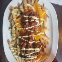 Fries Guy: Fries topped WITH BBQ jackfruit, vegan cheddar cheese, roasted jalapeño aioli at Puddlers Kitchen & Tap in Bridgeport